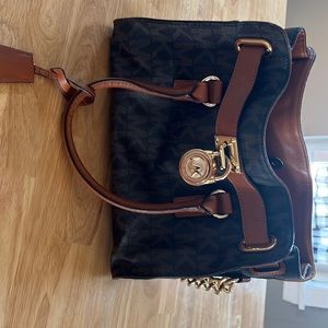 Genuine Michael Kors bag. Dark and light brown with gold chain on strap.